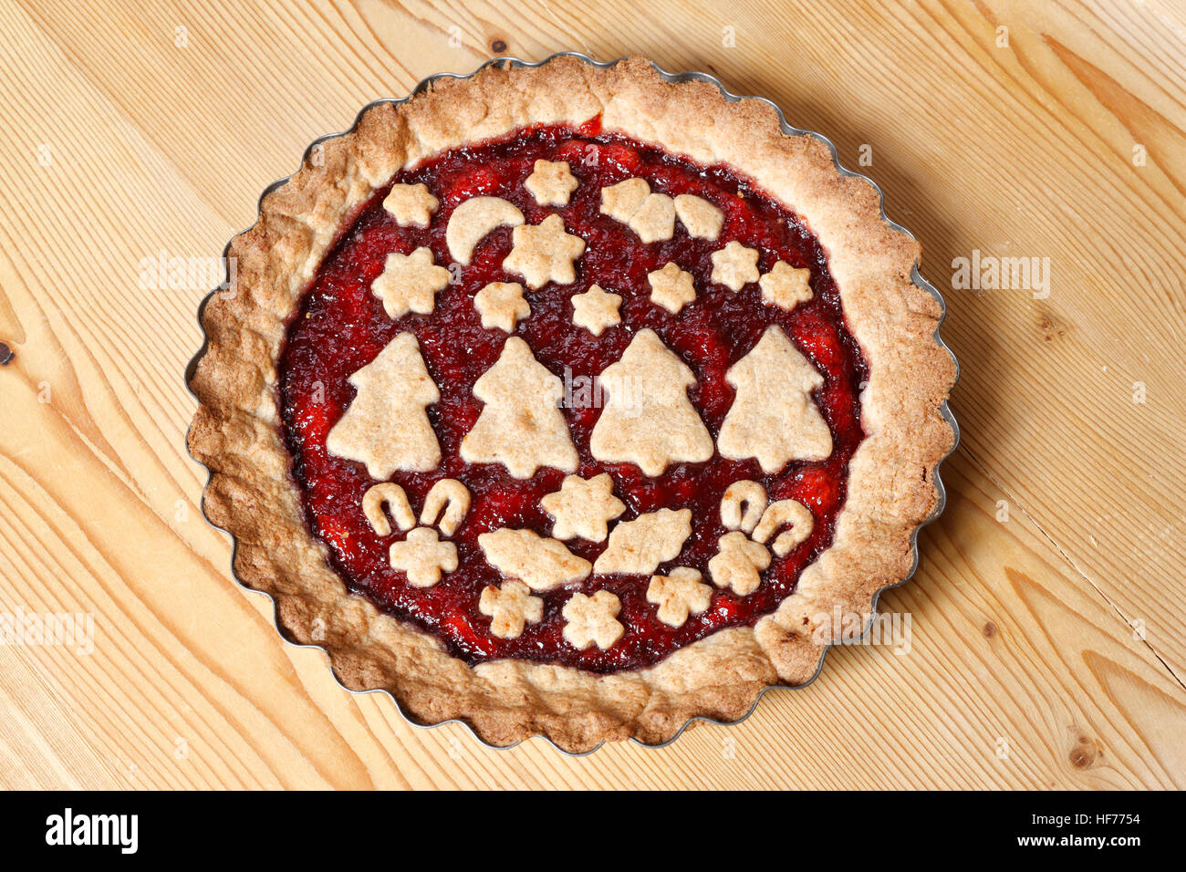 Decorated Linzer torte on wooden board Stock Photo