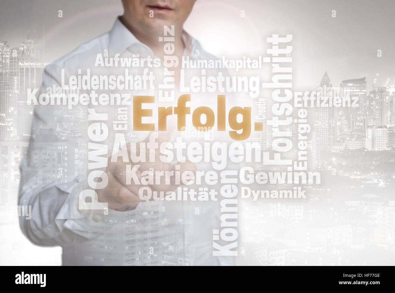 Erfolg Wordcloud (in german success) touchscreen is operated by man. Stock Photo