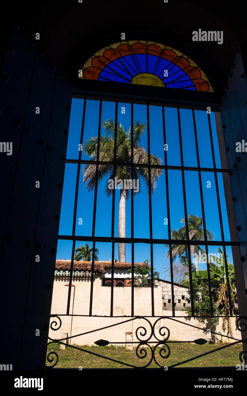 Palm tree seen through the barred window of the church, Vinales, Cuba Stock Photo