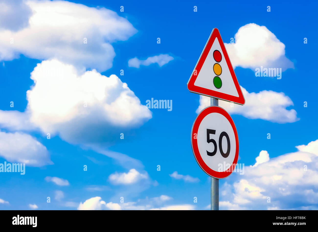 two road signs speed limit on a background of blue sky and clouds Stock