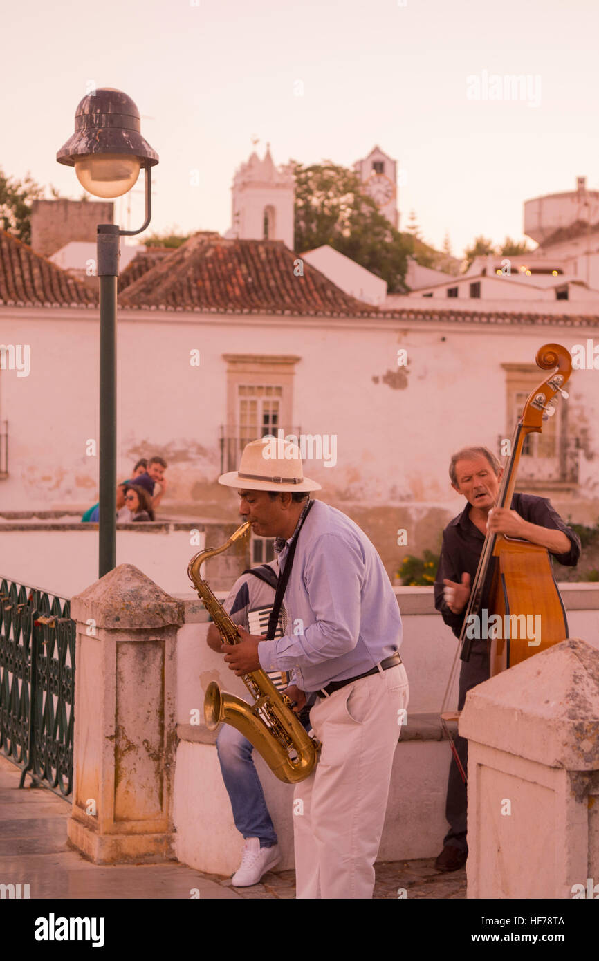 streetmusic on the Bridge Ponte Romana in the old town of Tavira at the east Algarve in the south of Portugal in Europe. Stock Photo