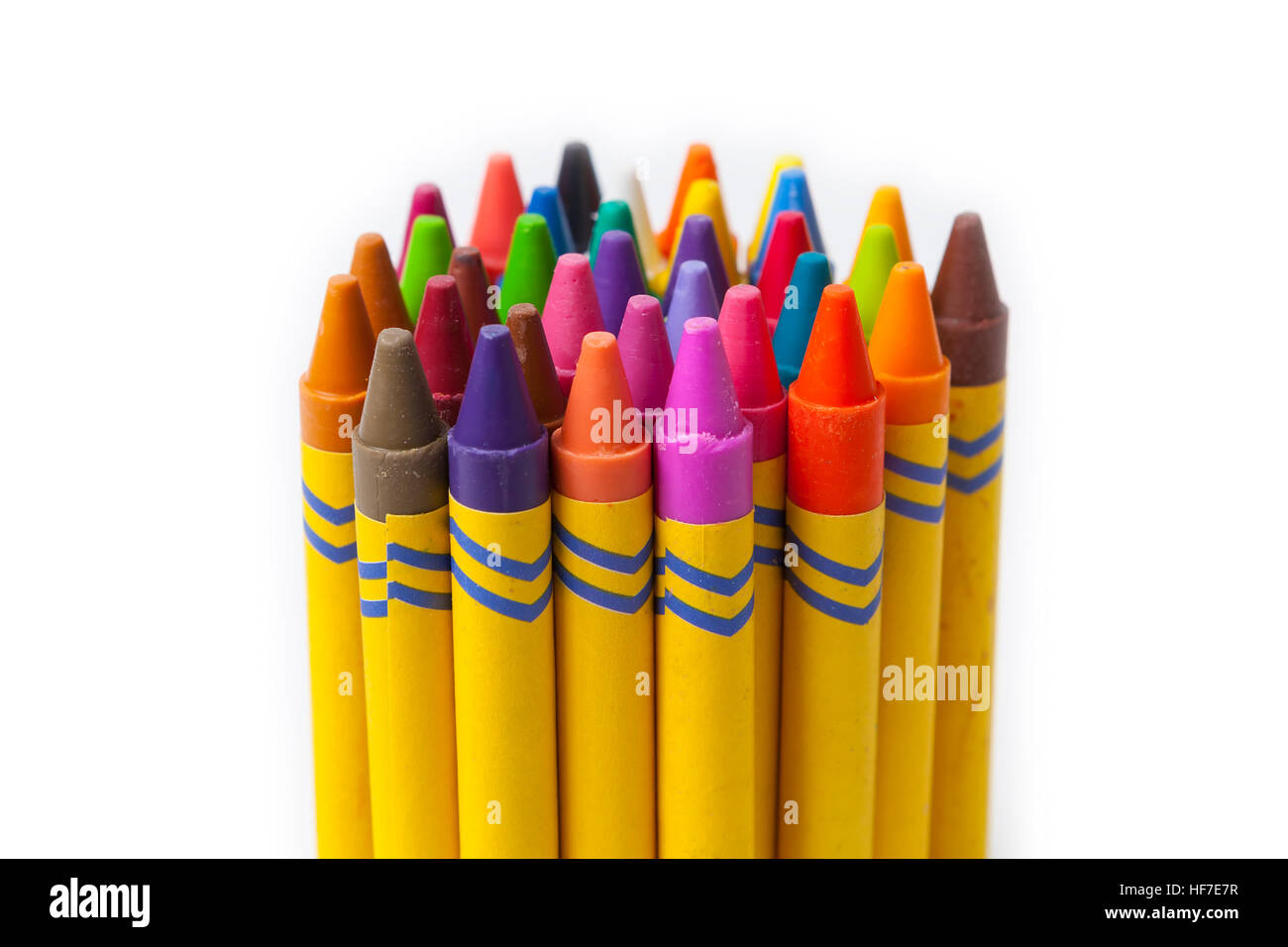 Colorful crayons grouped together over white background. Stock Photo