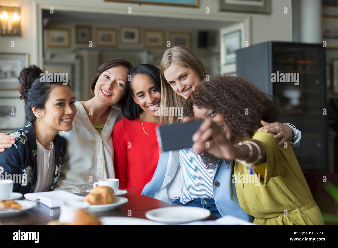 Smiling women friends taking selfie at restaurant table Stock Photo - Alamy