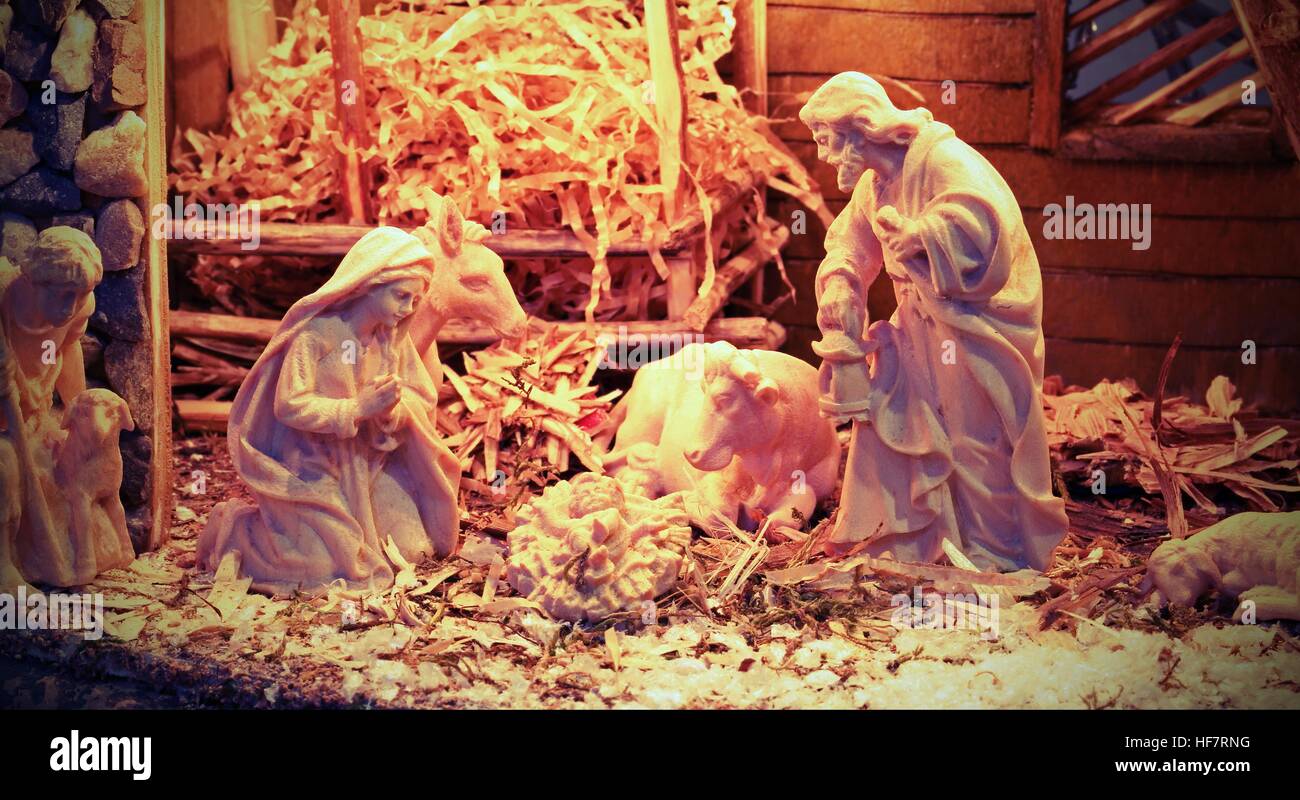 Nativity scene with beautiful wooden statues and the manger with straw and the ox Stock Photo