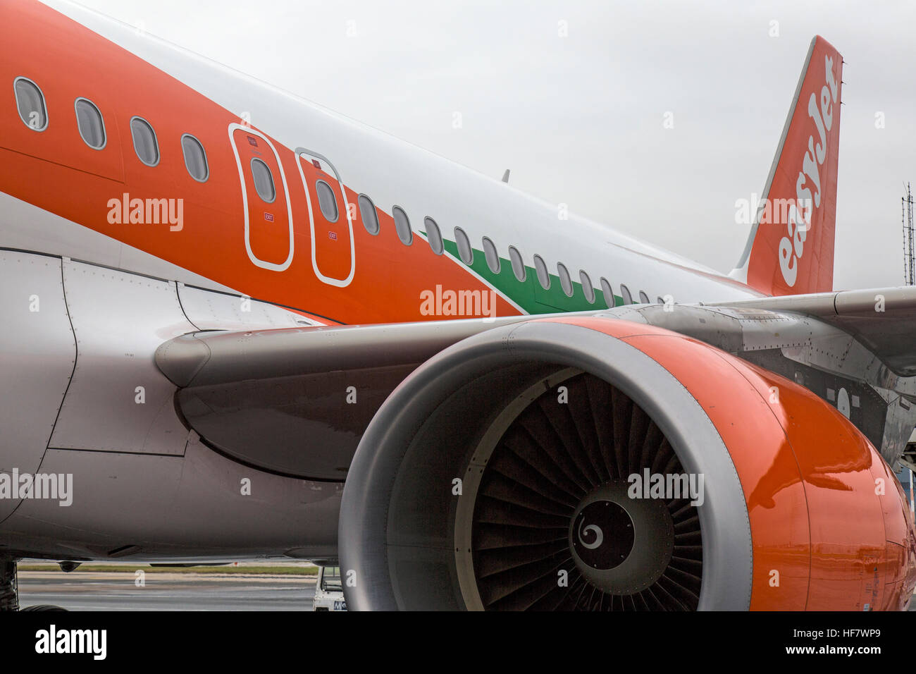 View of an Easyjet Airbus A320, showing fuselage, tail, and engine. Stock Photo