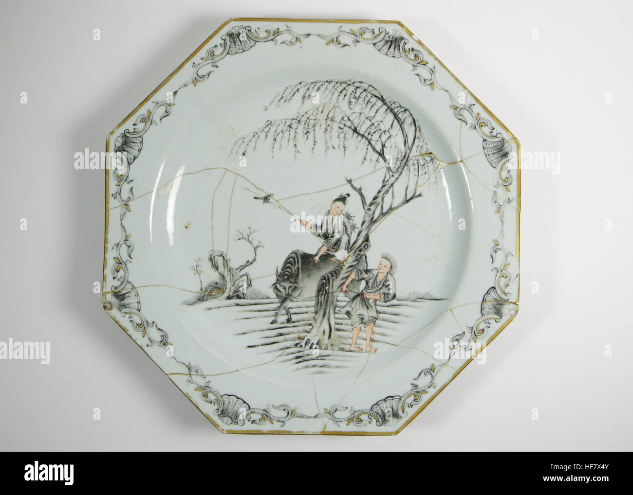 Antique 18th. Chinese large octagonal plate, painted en grisaille with a girl riding a buffalo and a boy beneath a tree. The large plate measures 35cm Stock Photo