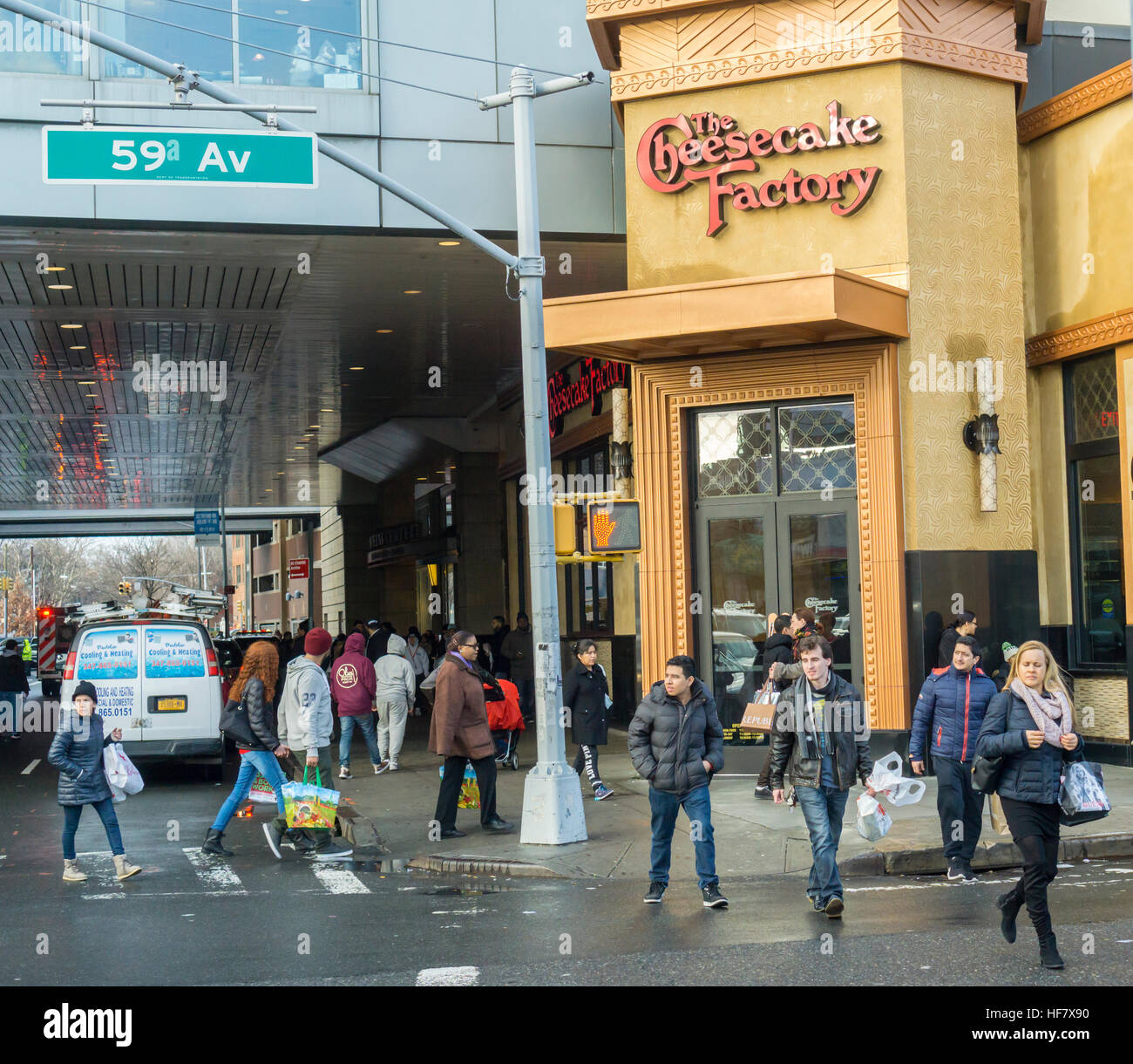 Shoppers leaving the Queens Center Mall pass the Cheesecake Factory casual dining restaurant in the borough of Queens in New York Super Saturday, December 24,  2016.  (© Richard B. Levine) Stock Photo