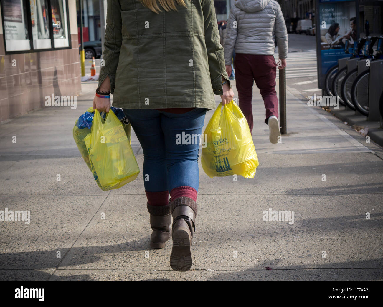 A shopper with her supermarket plastic bags in New York on Friday, December 23, 2016. After a delay earlier this year the New York City plastic bag bill, requiring a 5 cent fee on disposable plastic bags, is set to take effect in February 2017. (© Richard B. Levine) Stock Photo