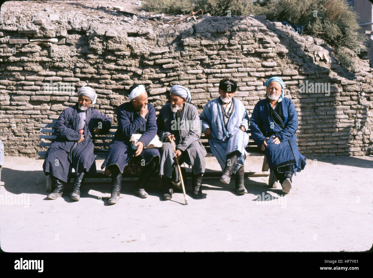 Old men in turbans, resting on a bench; Bukhara, Uzbekistan. Stock Photo