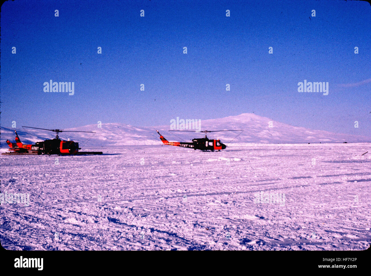 Mt. Terra Nova and Mt. Terror; Ross Island, Antarctica.  Navy helicopters in the middleground are used for transportation of supplies and scientists. Stock Photo