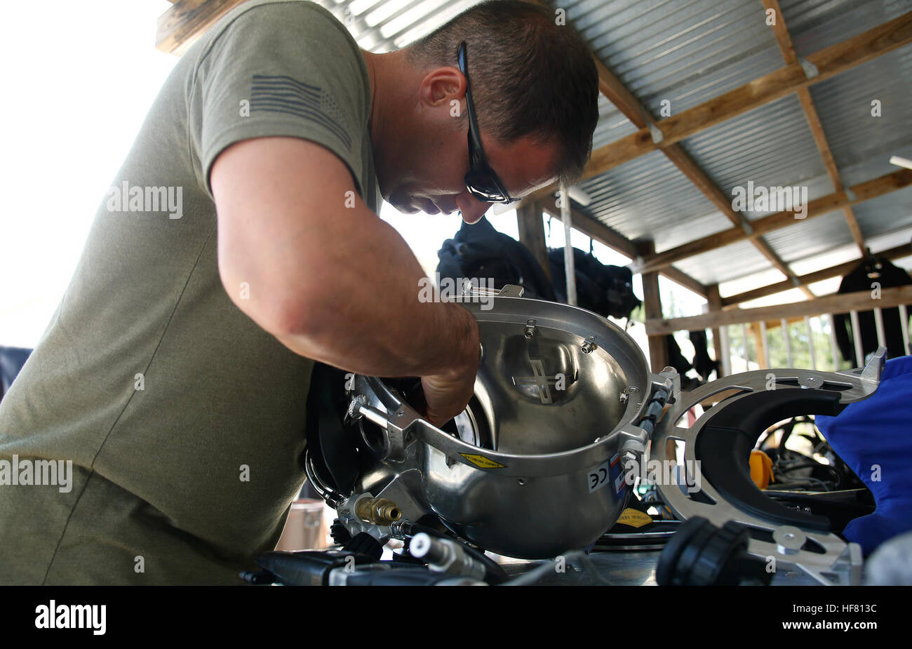 U.S. Border Patrol BORSTAR diver Juan Verdura inspects a Kirby Morgan diving helmet as he and his fellow divers stow away dive equipment after completing two weeks of advanced div training in Panama City, Fla., May 27, 2016.  by Glenn Fawcett Stock Photo