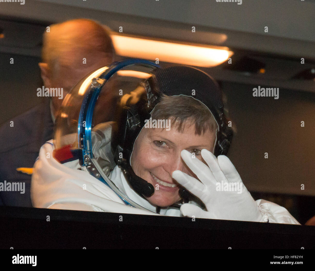 Expedition 50 NASA astronaut Peggy Whitson waves farewell to friends and family as she and ESA astronaut Thomas Pesquet and Russian cosmonaut Oleg Novitskiy of Roscosmos depart building 254 a few hours ahead of their launch, Thursday, Nov. 17, 2016, in Baikonur, Kazakhstan.  Whitson, Novitskiy, and Pesquet launched in their Soyuz MS-03 spacecraft to the International Space Station to begin a six-month mission. Victor Zelentsov) Stock Photo