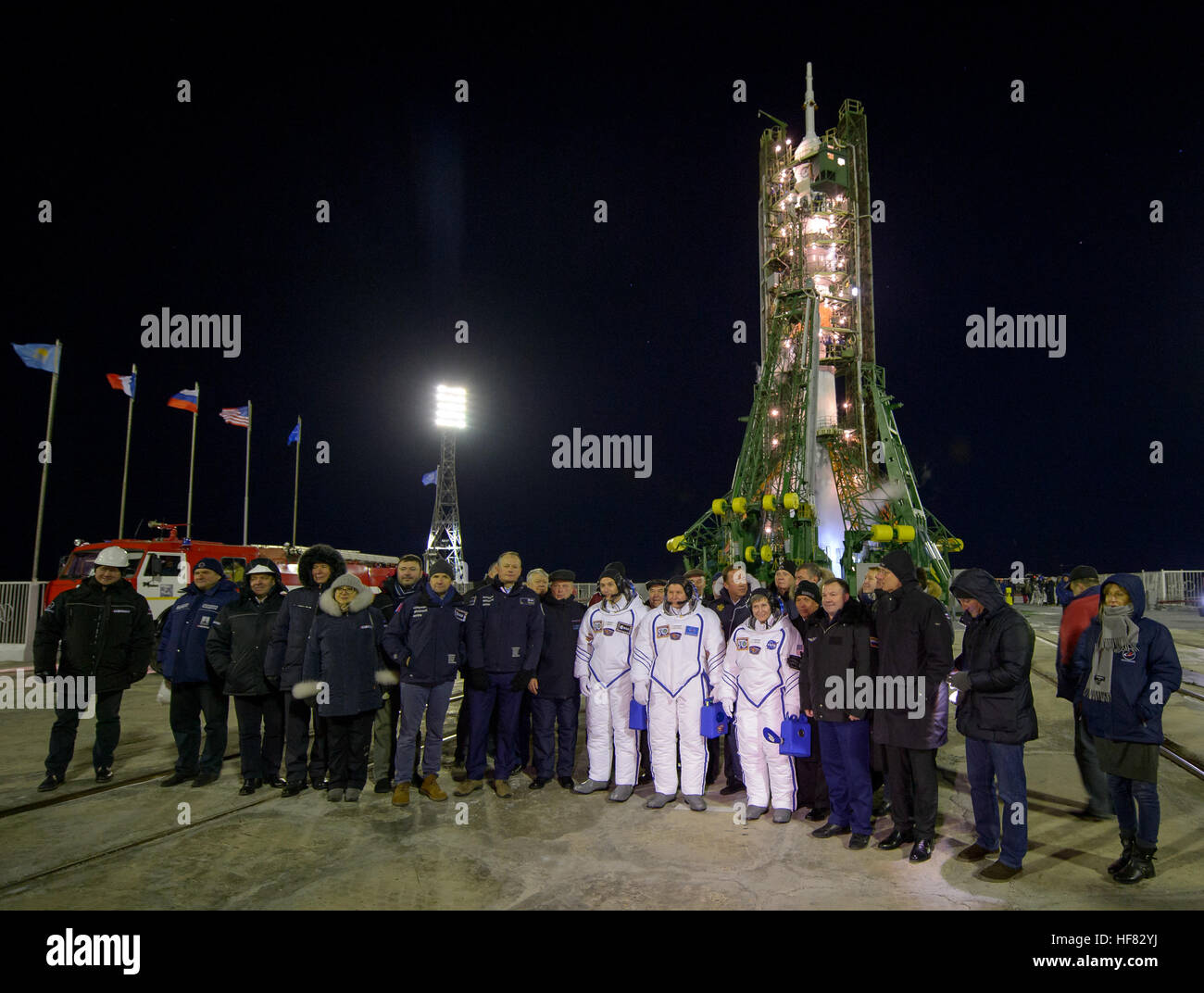 Expedition 50 crewmembers ESA astronaut Thomas Pesquet, left, Russian cosmonaut Oleg Novitskiy of Roscosmos, center, and NASA astronaut Peggy Whitson pose for a group photograph with mission managers in front of the Soyuz rocket at the launch pad, Thursday, Nov. 17, 2016, at the Baikonur Cosmodrome in Kazakhstan. Whitson, Novitskiy, and Pesquet will spend approximately six months on the orbital complex. Stock Photo