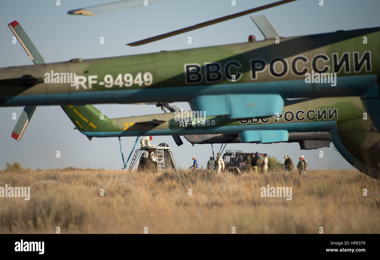 Russian support personnel work around the Soyuz TMA-20M spacecraft after it landed with with Expedition 48 crew members NASA astronaut Jeff Williams, Russian cosmonauts Alexey Ovchinin, and Oleg Skripochka of Roscosmos near the town of Zhezkazgan, Kazakhstan on Wednesday, Sept. 7, 2016(Kazakh time). Williams, Ovchinin, and Skripochka are returning after 172 days in space where they served as members of the Expedition 47 and 48 crews onboard the International Space Station. Stock Photo
