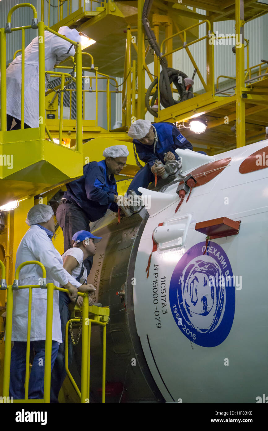 Workers monitor the encapsulation of the Soyuz MS-02 spacecraft in its fairing on Thursday, Tuesday, Oct. 11, 2016 at the Baikonur Cosmodrome in Kazakhstan.  Expedition 49 flight engineer Shane Kimbrough of NASA, flight engineer Andrey Borisenko of Roscosmos, and Soyuz commander Sergey Ryzhikov of Roscosmos are scheduled to launch from the Baikonur Cosmodrome in Kazakhstan on Oct. 19. Victor Zelentsov) Stock Photo