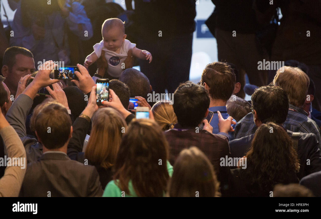 President Barack Obama holds up a baby wearing a NASA shirt as members of the audience take photos at the conclusion of the White House Frontiers Conference Thursday, October 13, 2016 at Carnegie Mellon University in Pittsburgh, PA. The conference, hosted by President Obama, and co-hosted by the University of Pittsburgh and Carnegie Mellon University, explores the future of innovation with a focus on building U.S. capacity in science and technology. Aubrey Gemignani) Stock Photo