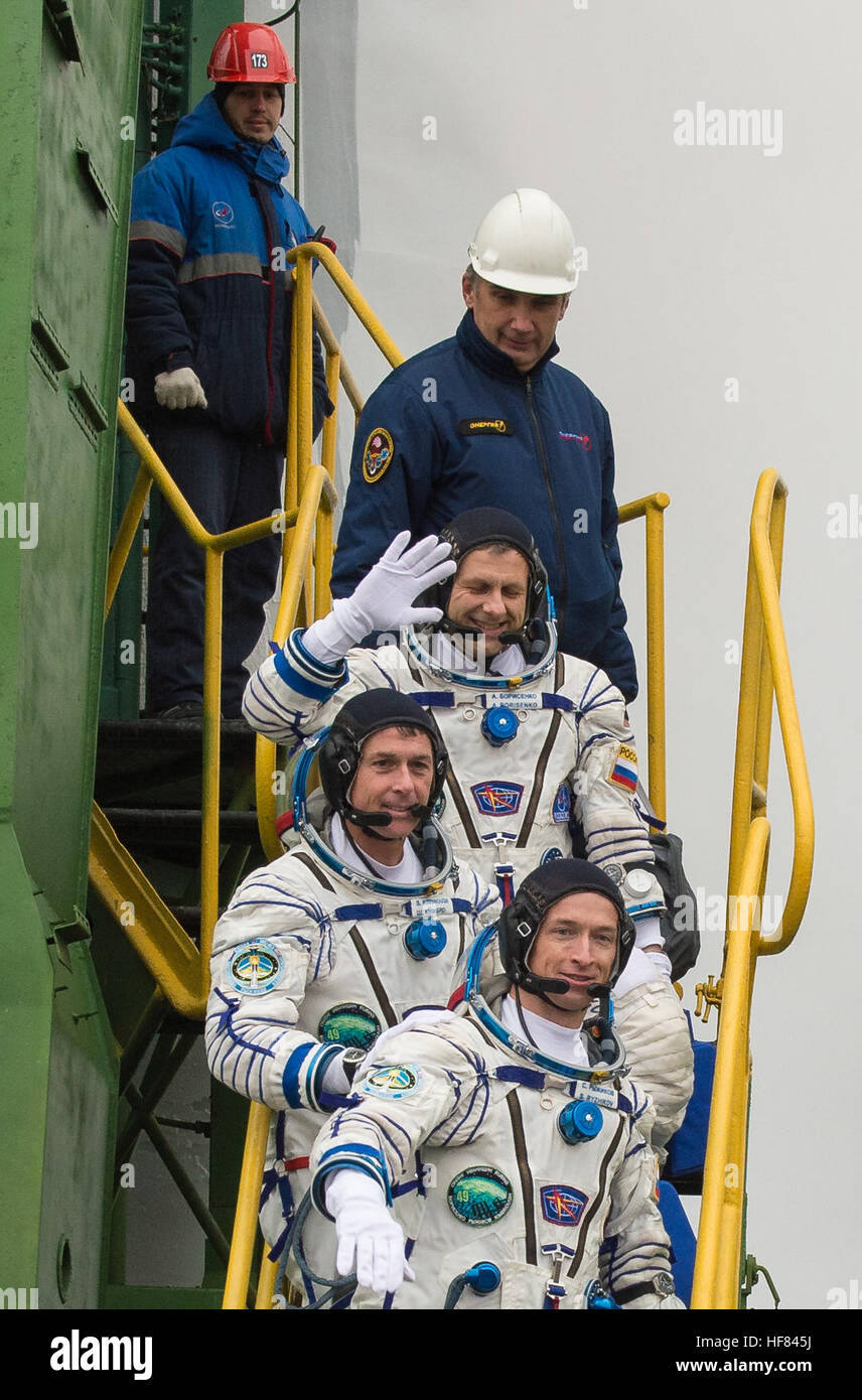 Expedition 49 flight engineer Andrey Borisenko of Roscosmos, top, flight engineer Shane Kimbrough of NASA, middle, and Soyuz commander Sergey Ryzhikov of Roscosmos, bottom, climb the ladder to the elevator as they prepare to board the Soyuz MS-02 rocket for launch, Wednesday, Oct. 19, 2016 at the Baikonur Cosmodrome in Kazakhstan.  Kimbrough, Borisenko, and Ryzhikov will spend the next four months living and working aboard the International Space Station. Stock Photo