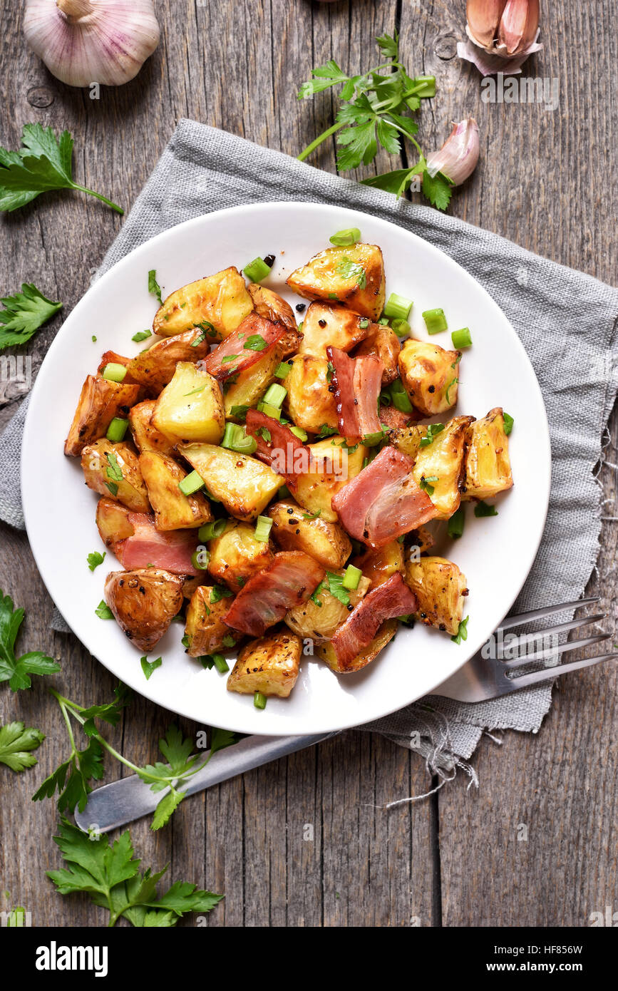 Roasted potato with bacon and green onion, top view, country style Stock Photo