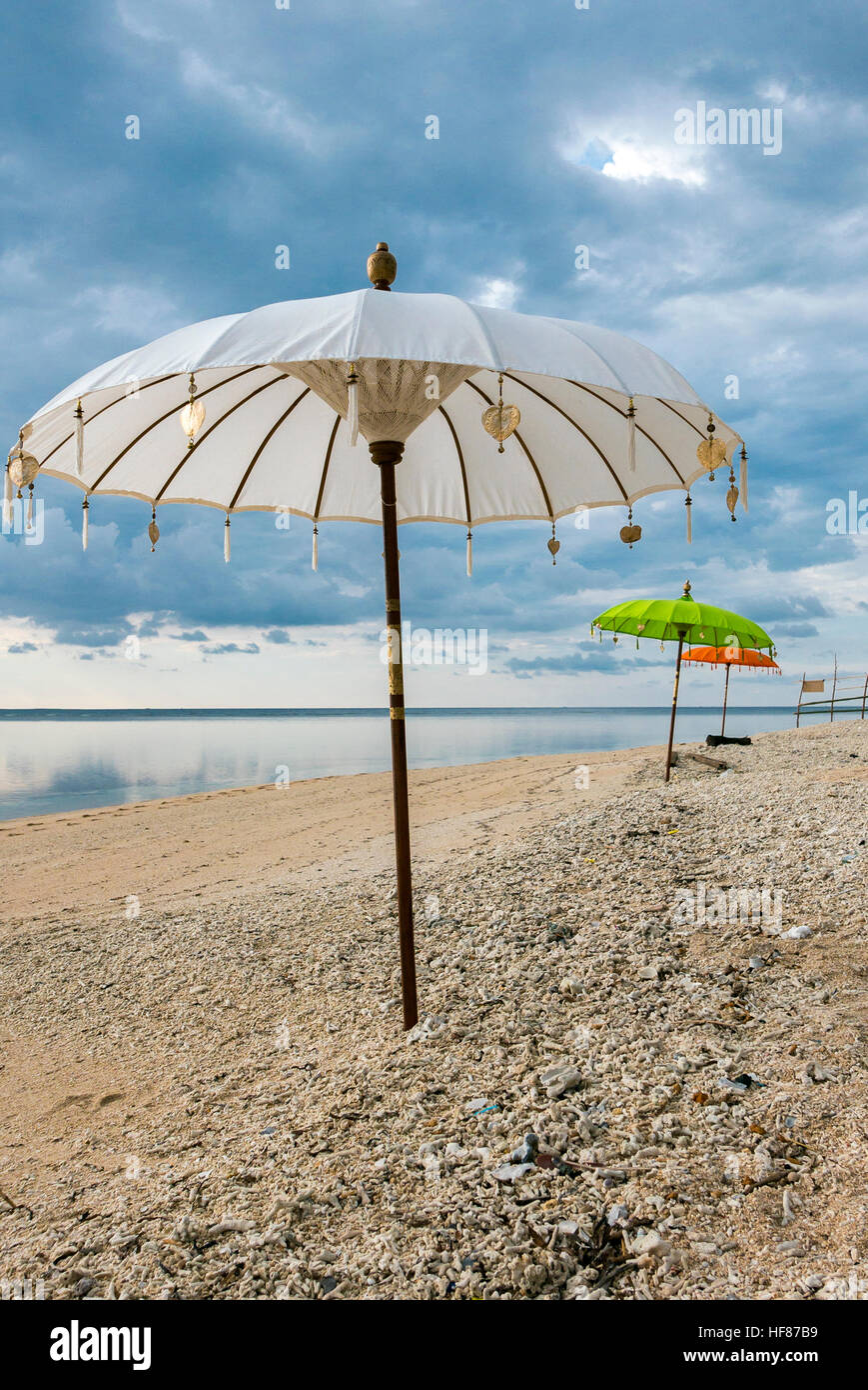Traditionall white and green Balinese umbrellas on the beach of Gili Air Stock Photo