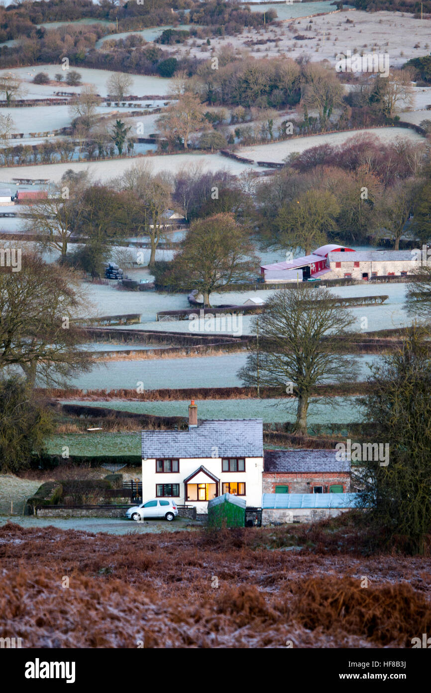 A Farm house surrounded by frozen blanketed fields in the village of