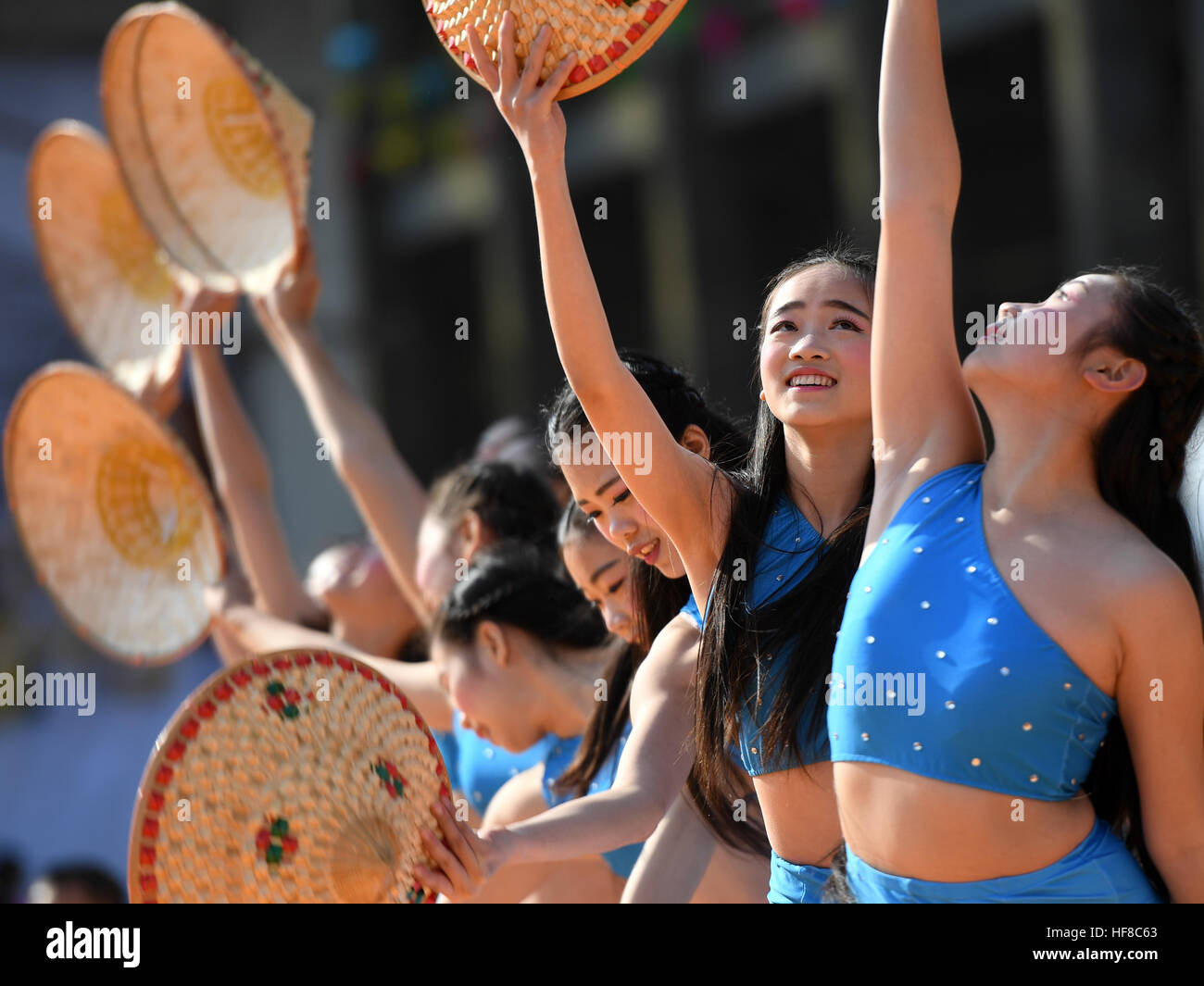 Rongan, China's Guangxi Zhuang Automonous Region. 28th Dec, 2016. Women perform in Chang'an Township in Rong'an County, south China's Guangxi Zhuang Automonous Region, Dec. 28, 2016. A celebration was held for the harvest of kumquat fruit here on Wednesday. © Lu Bo'an/Xinhua/Alamy Live News Stock Photo