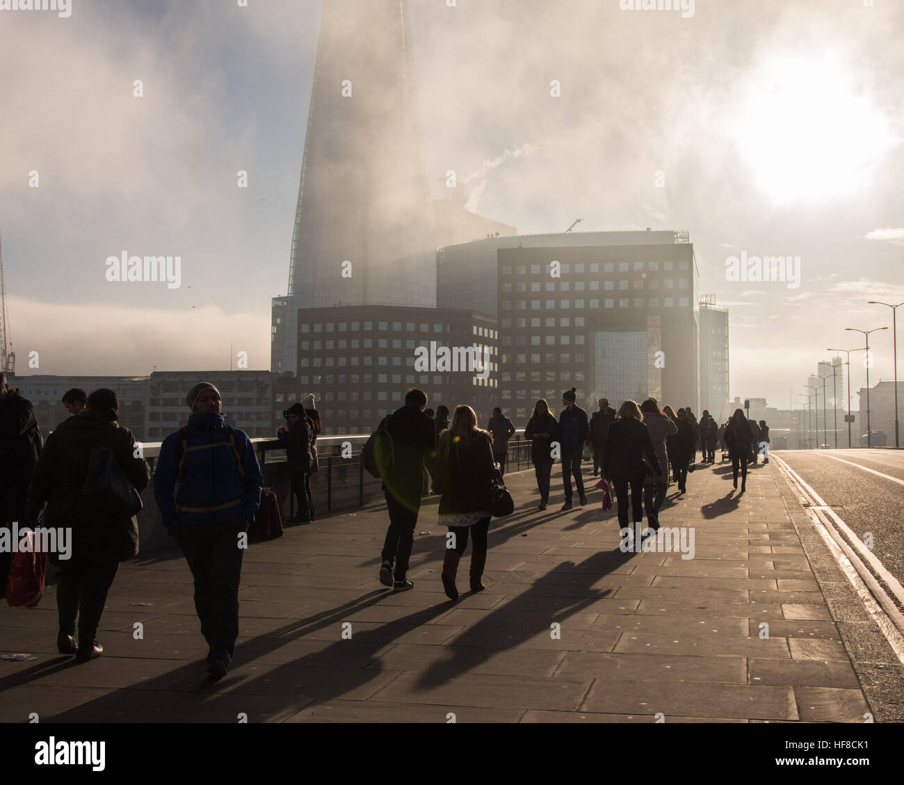 London, UK 28th December 2016. Drifting fog and low cloud makes for a day of magical light in central London.  The Shard skyscraper looked particularly dramatic as people cross London Bridge. © Patricia Phillips/ Alamy Live news Stock Photo