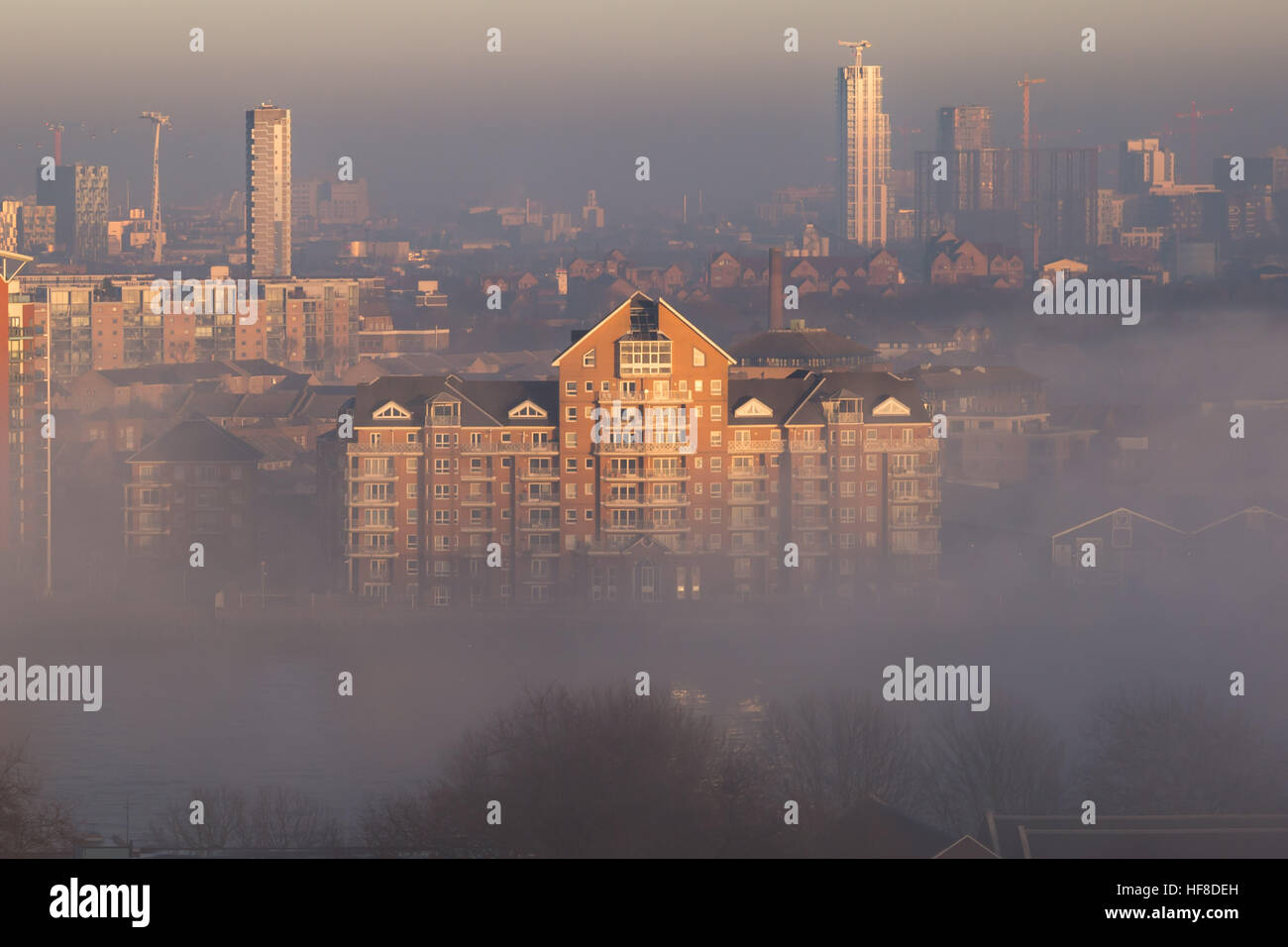 London, UK. 28th December, 2016. Poseidon Court, Homer Drive riverside flats seen through heavy fog over River Thames © Guy Corbishley/Alamy Live News Stock Photo