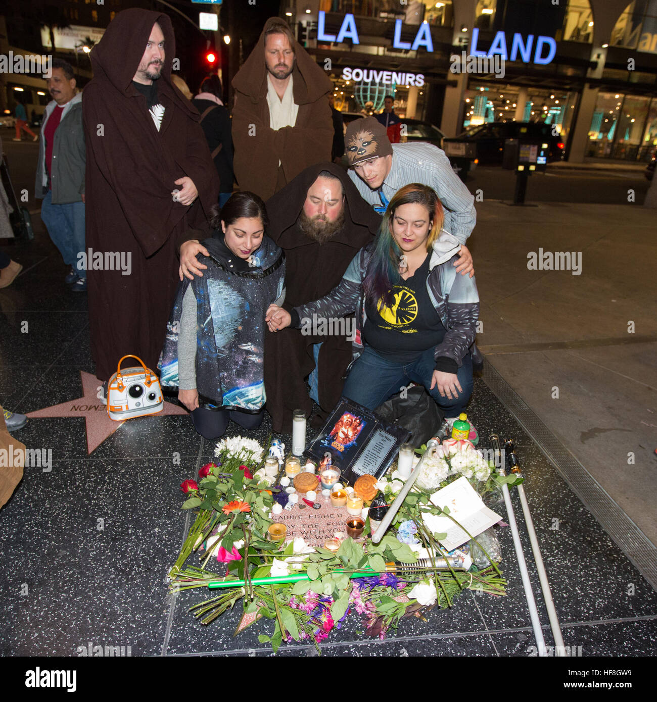 Hollywood, California, USA. 28th December, 2016. Fans of actress Carrie Fisher, who passed away yesterday, gather around a makeshift star on the Hollywood Walk of Fame in Hollywood, California, USA.  As Carrie Fisher does not have an official star on the Hollywood Walk of Fame, her fans created one from a blank star near the historic TCL Chinese Theatre (originally Grauman's Chinese Theatre) where Star Wars movies have had their premieres. Credit:  Sheri Determan/Alamy Live News Stock Photo