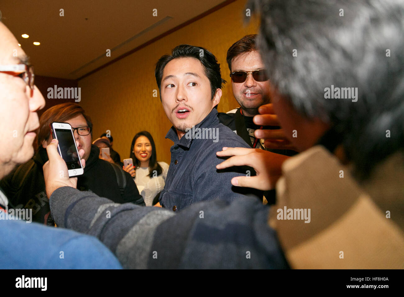Actor Steven Yeun greets fans during the 11th Hollywood Collector's Convention at Shinagawa Prince Hotel on December 29, 2016, Tokyo, Japan. Four of the cast members for the popular TV series The Walking Dead visited Japan to promote the show and spend time with the fans during the 2-day event which started today. © Rodrigo Reyes Marin/AFLO/Alamy Live News Stock Photo