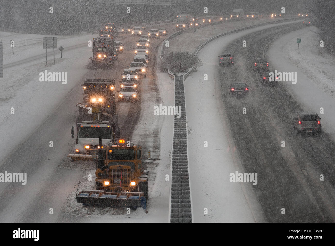 Westminster, Massachusetts, USA. 29 December, 2016. A battery of snowplows, sometimes referred to as a 'conga line' back up traffic behind them as they clear Rt 2 in Westminster, Mass. A winter storm projected to bring about a foot of snow to north central Massachusetts impacted the roads and the subsequent afternoon commute with many crashes reported throughout the region. Oncoming traffic is headed eastbound.   © Jim Marabello/ Alamy Live News Stock Photo