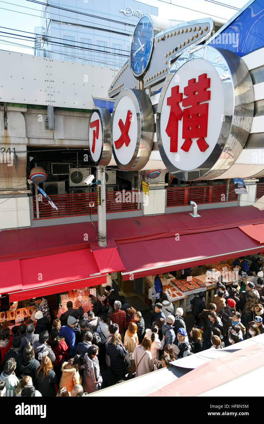 People shop along the street of Ameyoko district near Ueno station on December 30, 2016, Tokyo, Japan. Ameya Yokocho (Ameyoko) is a narrow shopping street with more than 500 retailers where year-end shoppers gather to buy traditional food for the New Year celebration (called osechi-ryori). © Rodrigo Reyes Marin/AFLO/Alamy Live News Stock Photo