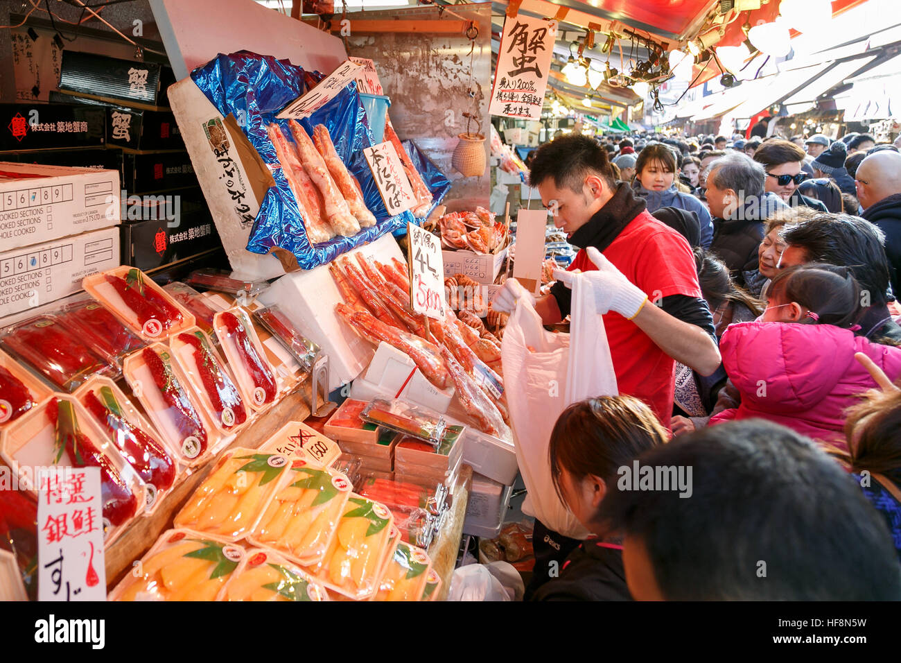 People shop along the street of Ameyoko district near Ueno station on December 30, 2016, Tokyo, Japan. Ameya Yokocho (Ameyoko) is a narrow shopping street with more than 500 retailers where year-end shoppers gather to buy traditional food for the New Year celebration (called osechi-ryori). © Rodrigo Reyes Marin/AFLO/Alamy Live News Stock Photo