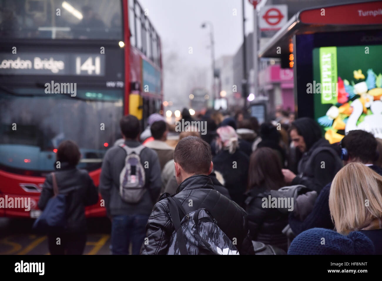 Turnpike Lane, London, UK. 30th December 2016. People queue for the buses at rush hour after the Piccadilly Line is cancelled Stock Photo