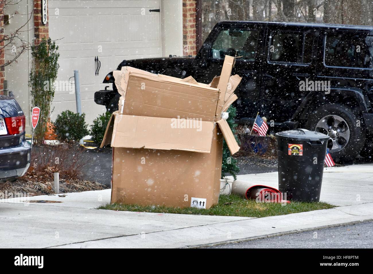 Hanover, Maryland, USA. 30th December, 2016. Trash and recycling bins lay out on street while they are being snowed on and blown over or across the road from the windy, cold, and snowy weather in Anne Arundel County Maryland. Credit: Jeramey Lende/Alamy Live News Stock Photo