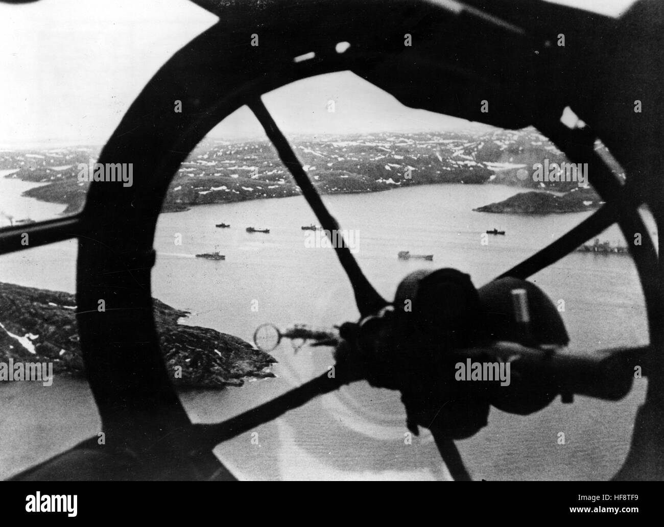The Nazi propaganda image shows a view from the cockpit of a German Luftwaffe Heinkel He 111 combat plane on a mission over Norway. Published in September 1944. A Nazi reporter has written on the reverse on 01.09.1944, 'Security flight over the Arctic Ocean. The full-view cockpit provides an overview of a supply convoy leaving a Fjord in the Arctic. Fotoarchiv für Zeitgeschichte - NO WIRELESS SERVICE -  | usage worldwide Stock Photo