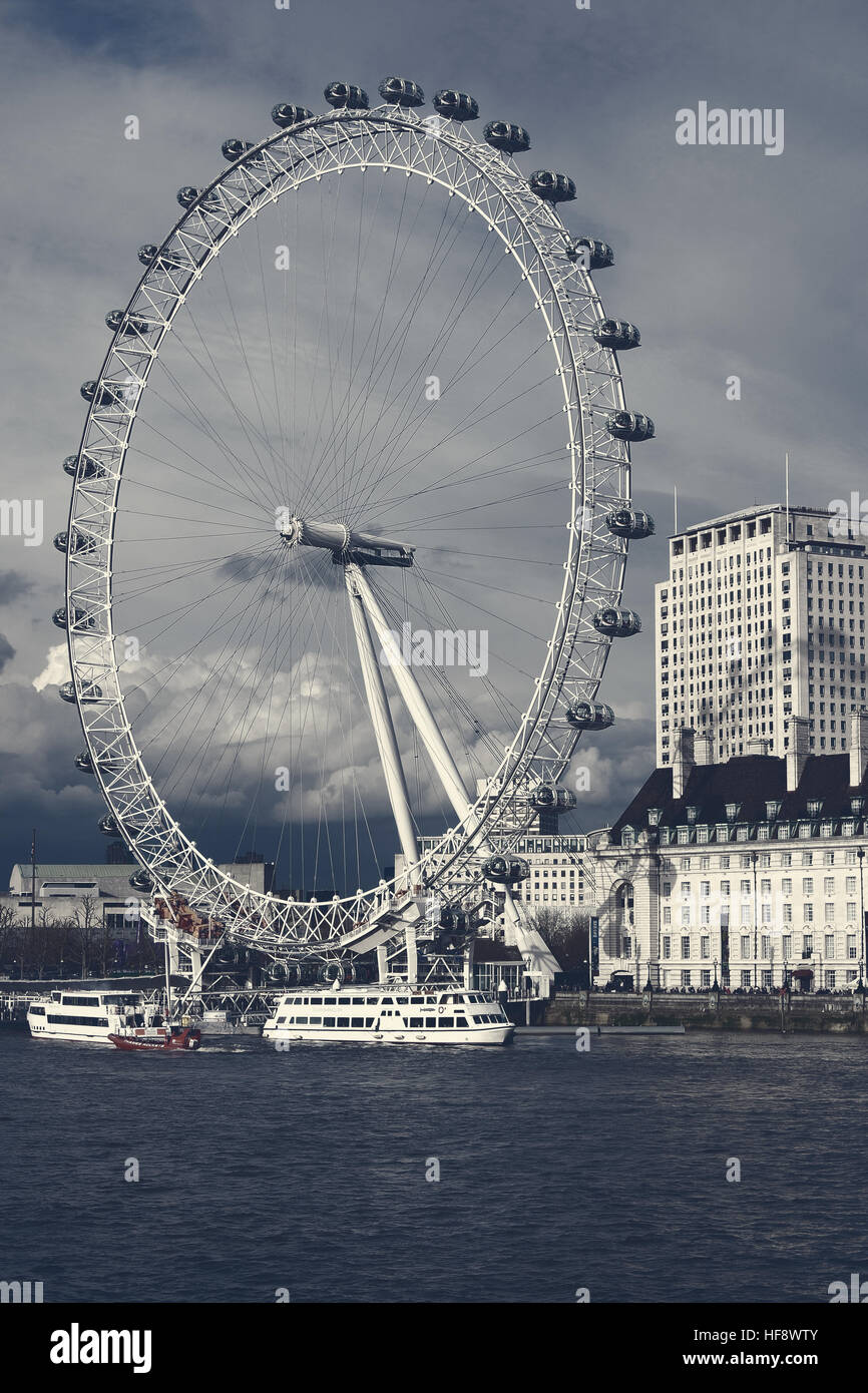 London Eye view from Westminster Bridge. Graded using a cross processing filter to increase the mood. Stock Photo