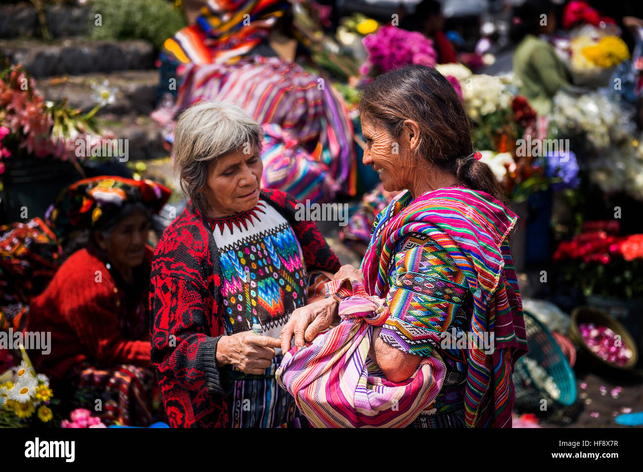 Chichicastenango, Guatemala - April 27, 2014: Two local women wearing traditional clothing in a market in Chichicastenango. Stock Photo
