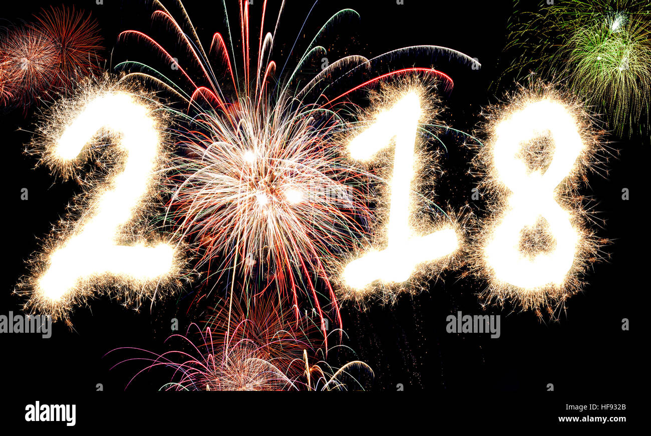 3D rendering of Happy New Year Fireworks with the year 2018 lit up in glowing sparkles and light. Stock Photo