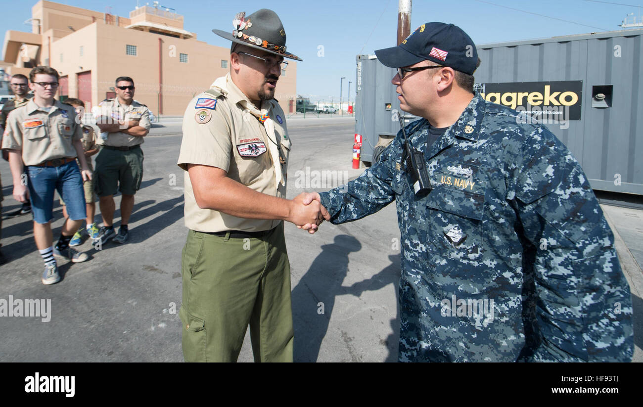151205-N-CJ186-257 NAVAL SUPPORT ACTIVITY BAHRAIN (Dec. 5, 2015) Assistant Scoutmaster Alex Bedoya, with the Boy Scouts of America, meets with Chief Mineman Shane Stone, assigned to the Avenger-class mine countermeasures ship USS Sentry (MCM 3), before a tour of the Sentry. Troops 221 and 826, based out of Saudi Arabia and the Kingdom of Bahrain, took part in the tour to earn the Citizenship in the Nation Merit Badge, in which they visit two U.S. government facilities to earn the merit. USS Sentry is currently assigned to Commander, Task Group 52.2, which conducts mine countermeasure, explosiv Stock Photo