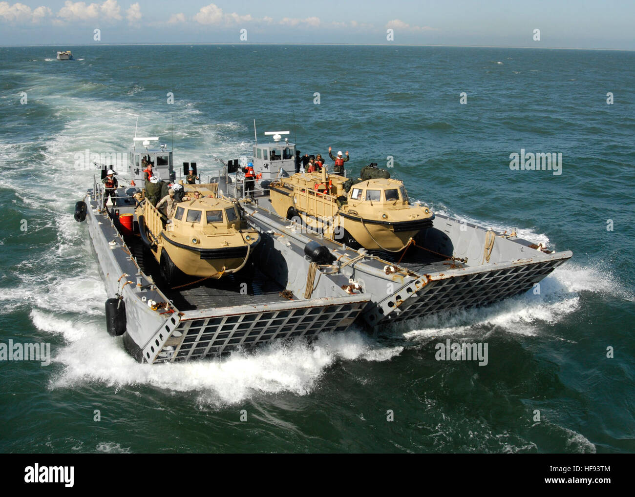 Two landing craft mechanized (LCM) vessels carry vehicles to the amphibious dock landing ship USS Fort McHenry (LSD 43) before the ship?s departure from Moorehead City, N.C., March 13, 2010. Fort McHenry has returned stateside after participating in Operation Unified Response, a multinational effort to assist Haitians affected by the 7.0-magintude earthquake that struck Haiti Jan. 12, 2010. (DoD photo by Mass Communication Specialist 1st Class Darryl I. Wood, U.S. Navy/Released) 100313-N-9301W-084 (4438755918) Stock Photo