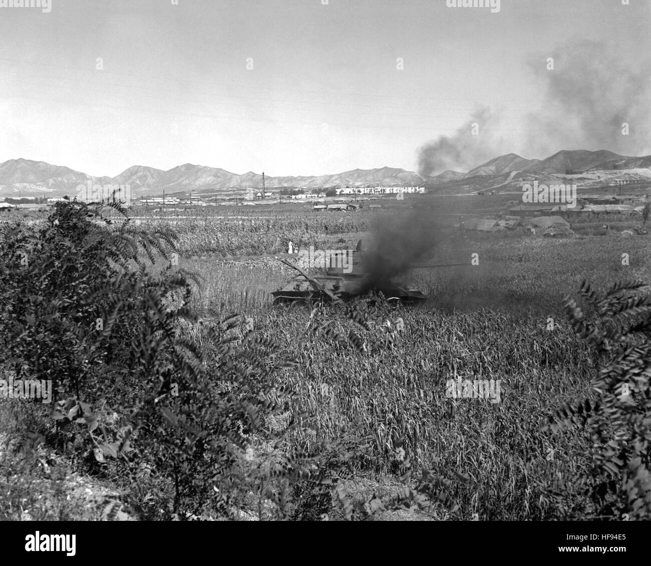 Russian T-34 tanks north of Inchon, knocked out and burning after U.S. Marines get hits on them.  Russian T-34 tank burns in field. NARA FILE #:  80-G-421167 Burning T-34-85 medium tank, destroyed by U.S. Marines, north of Inchon Stock Photo