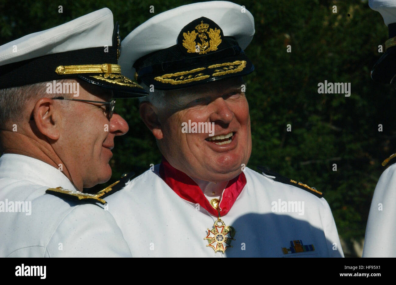 020924-N-2383B- 592 Washington, D.C. (September 24, 2002) -- Presented the Legion of Merit by Admiral Vern Clark, Chief of Naval Operations (CNO), Vice Admiral Cees van Duyvendijk, Commander in Chief, Royal Netherlands Navy, talks with a member of the official party at the conclusion of a full honors ceremony on his behalf.  The distinct history of the Legion of Merit is itÕs the first American decoration awarded to citizens of other nations.  U.S. Navy photo by Chief Photographer's Mate Johnny Bivera.  (RELEASED) Cees van Duyvendijk Stock Photo