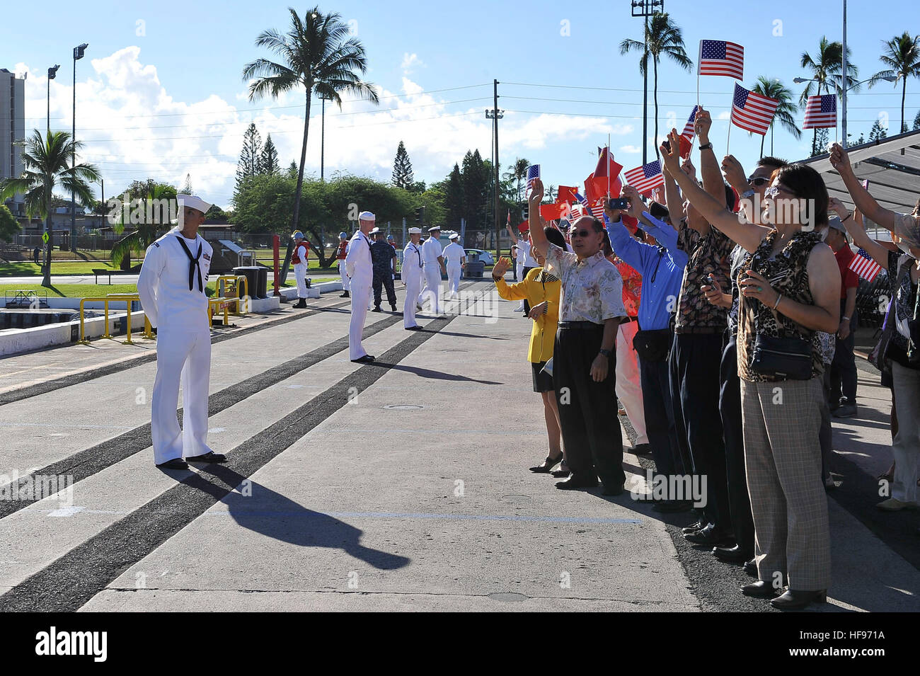 Various members of the Chinese-American community here welcome the People's Liberation Army-Navy Luhu-class destroyer Qingdao (DDG 113) as it pulls into Joint Base Pearl Harbor-Hickam, Friday, Sept. 6. This port visit is part of the U.S. Navy's ongoing effort to maximize opportunities for developing relationships with foreign navies as a tool to build trust, encourage multilateral cooperation, enhance transparency, and avoid miscalculation in the Pacific. (Department of Defense photo by U.S. Navy Petty Officer 1st Class Cynthia Clark/Released) Chinese navy ships visit Hawaii 130906-N-PJ759-009 Stock Photo