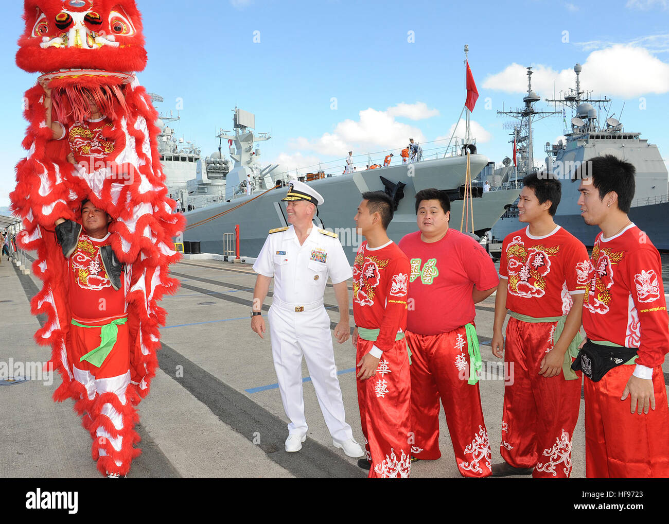 130906-N-ZK021-004 – PEARL HARBOR-HICKAM (Sept. 6, 2013) – Rear Adm. Rick Williams, commander, Navy Region Hawaii and Naval Surface Group Middle Pacific interacts with Chinese lion dancers prior to their performance during the arrival ceremony for three People’s Liberation Army-Navy ships Luhu-class destroyer Qingdao (DDG 113), Jiangkai-class frigate Linyi (FFG 547) and a Fuqing-class fleet oiler as they arrive in Hawaii for a scheduled port visit. Over the weekend, Chinese and U.S. leaders will conduct dialogues to build confidence and mutual understanding between the two nations. The port vi Stock Photo