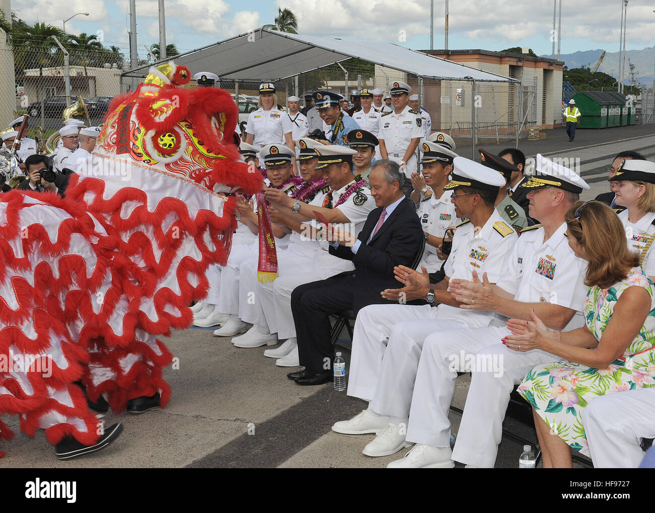 130906-N-ZK021-007 – PEARL HARBOR-HICKAM (Sept. 6, 2013) – U.S. and Chinese leaders watch as lion dancers perform during an arrival ceremony for three People’s Liberation Army-Navy ships Luhu-class destroyer Qingdao (DDG 113), Jiangkai-class frigate Linyi (FFG 547) and a Fuqing-class fleet oiler as they arrive in Hawaii for a scheduled port visit. Over the weekend, Chinese and U.S. leaders will conduct dialogues to build confidence and mutual understanding between the two nations. The port visit is part of the U.S. Navy’s ongoing effort to maximize opportunities for developing relationships wi Stock Photo
