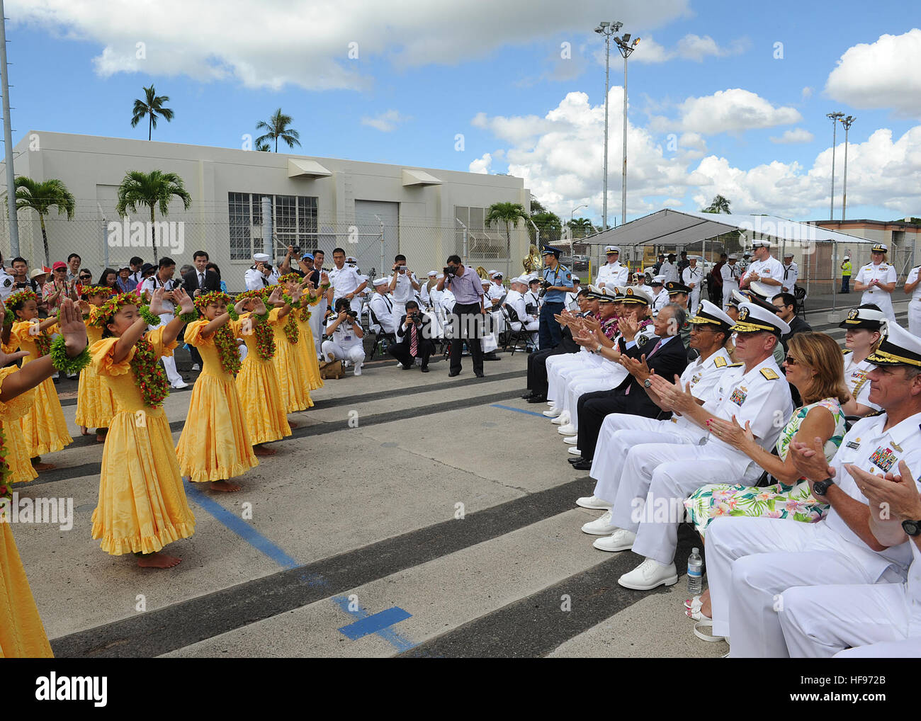 130906-N-ZK021-010 – PEARL HARBOR-HICKAM (Sept. 6, 2013) – U.S. and Chinese leaders watch as Keiki Hula dancers perform during an arrival ceremony for three People’s Liberation Army-Navy ships, Luhu-class destroyer Qingdao (DDG 113), Jiangkai-class frigate Linyi (FFG 547) and a Fuqing-class fleet oiler as they arrive in Hawaii for a scheduled port visit. Over the weekend, Chinese and U.S. leaders will conduct dialogues to build confidence and mutual understanding between the two nations. The port visit is part of the U.S. Navy’s ongoing effort to maximize opportunities for developing relations Stock Photo