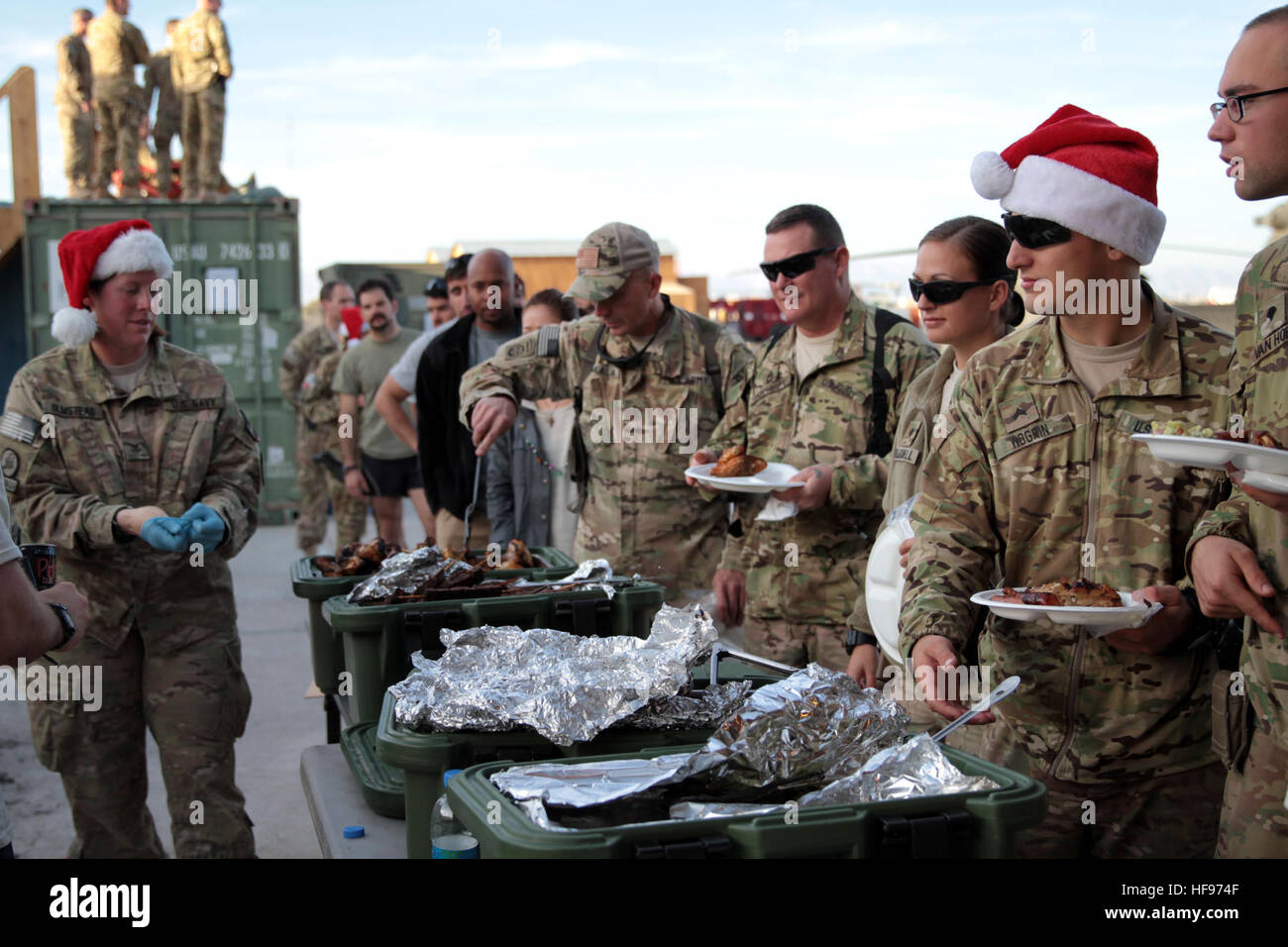 Coalition force military members and civilians line up for Christmas