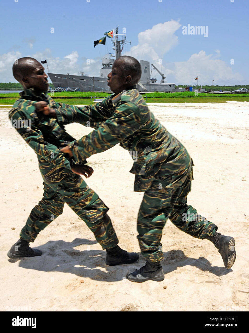Guyanese coast guard sailors demonstrate a takedown drill during a Marine Corps Martial Arts Program (MCMAP) tan belt test in Georgetown, Guyana, Sept. 3, 2010. U.S. Marines embarked aboard high-speed vessel Swift (HSV-2) are facilitating the MCMAP session in support of Southern Partnership Station (SPS) 2010. SPS is designed to promote information-sharing with navies, coast guards and civilian services throughout the U.S. Southern Command area of responsibility. (DoD photo by Mass Communication Specialist 1st Class Kim Williams, U.S. Navy/Released) 100903-N-9643W-0778 (4967542361) Stock Photo
