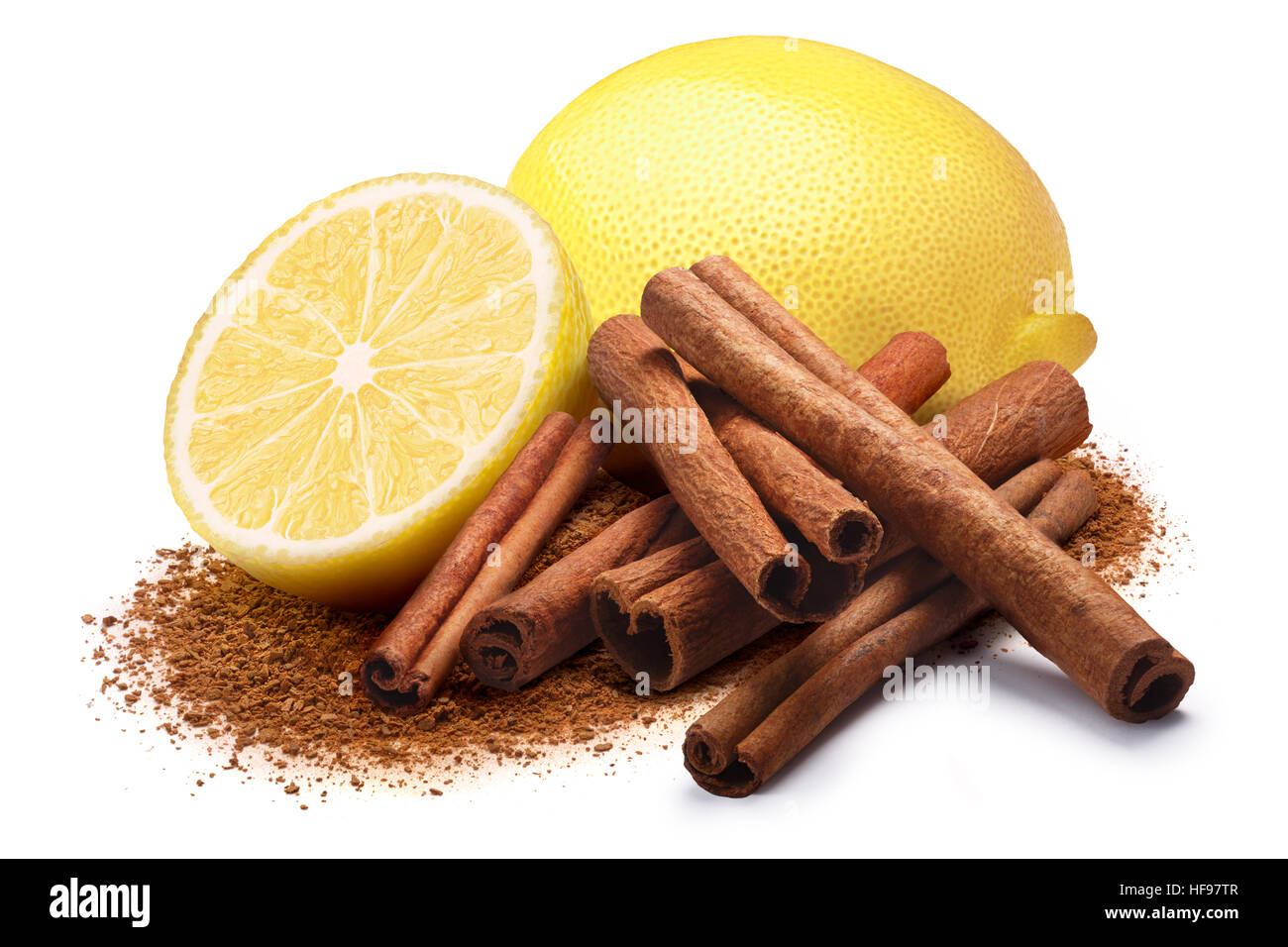 Whole and a half of lemon next to pile of cinnamon sticks and ground