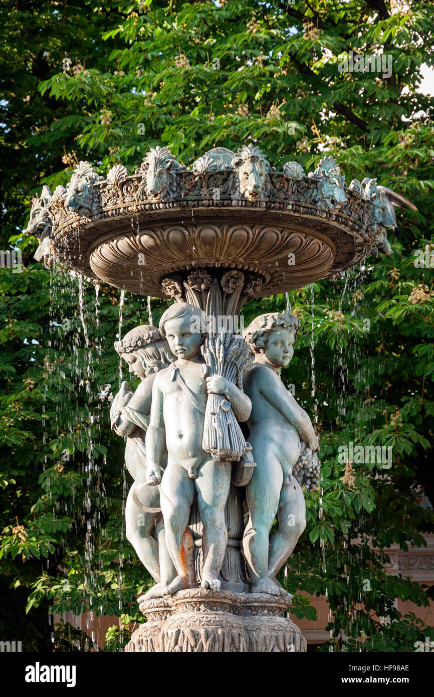 Garden water fountain with statues of little boys. Paris, France Stock